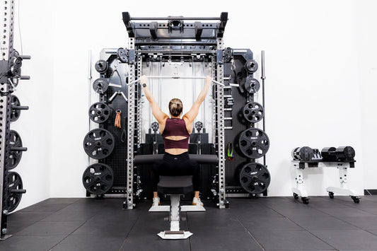 Athlete works on the Wall-Mounted REP ARES™ 2.0.