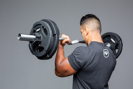 Athlete curls the REP EZ Curl Bar.
