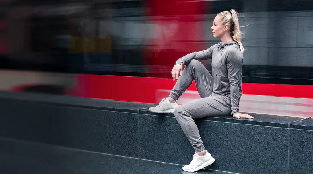 A woman sits outside in REP apparel.