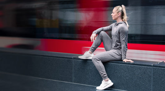 Athlete sits in Vellus Joggers and Vellus Hoodie.
