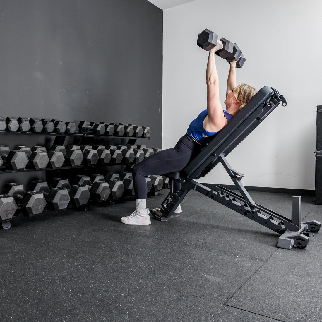 Athlete working out in front of the REP Fitness Dumbbell Rack 2.0