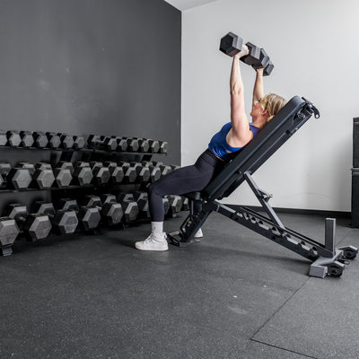 Athlete working out in front of the REP Fitness Dumbbell Rack 2.0