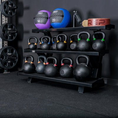 REP Fitness 3-Tier Kettlebell Rack 2.0 loaded with kettlebells and accessories