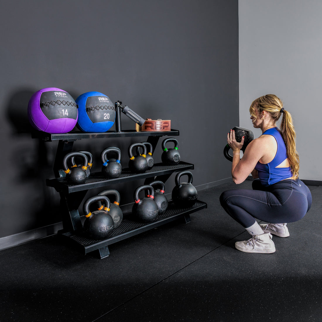 Athlete working out in front of the REP Fitness 3-Tier Kettlebell Rack 2.0