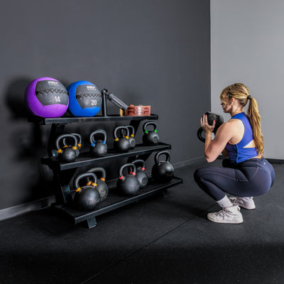 Athlete working out in front of the REP Fitness 3-Tier Kettlebell Rack 2.0