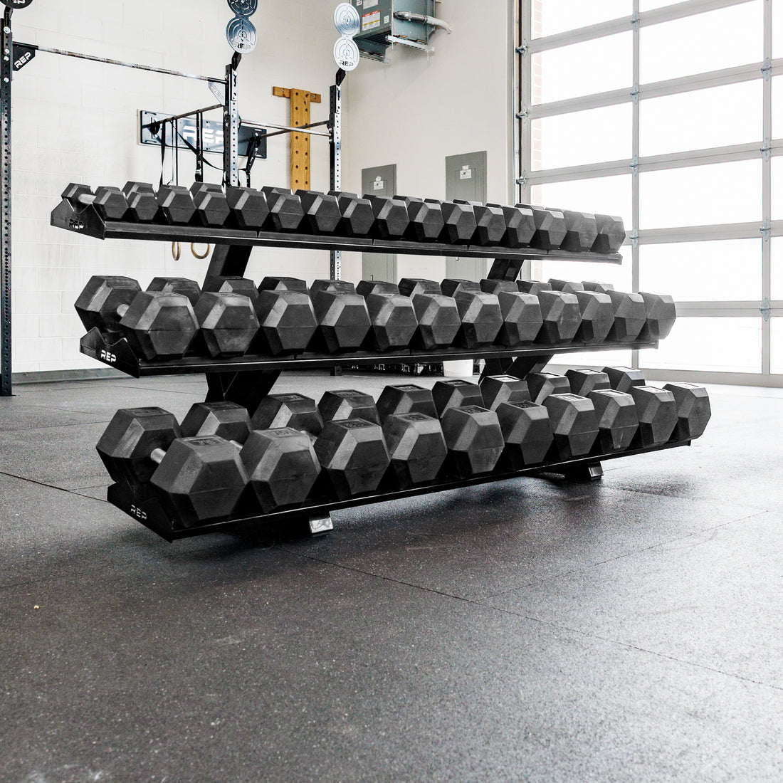 REP Fitness 3-Tier Commercial Dumbbell Rack loaded with Hex dumbbells