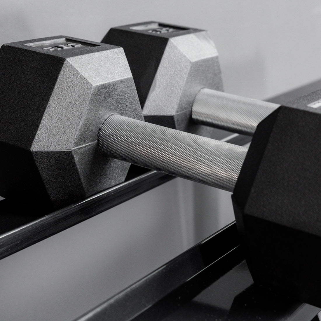 Close-up shot of hex dumbbells racked on the REP Fitness Dumbbell Rack 2.0