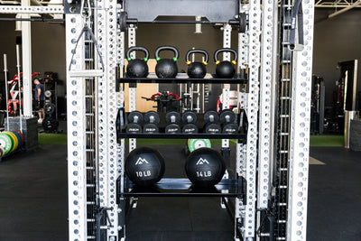 Kettlebells, Dumbbells, and Med balls stored on REP Fitness 41in Dumbbell & Kettlebell Shelves