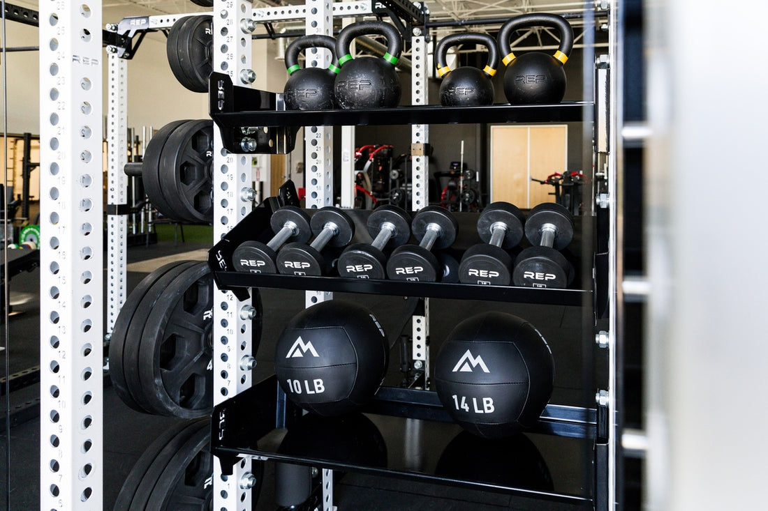 REP Fitness 41in Dumbbell & Kettlebell Shelves with Kettlebells, Dumbbells, and Med balls on them