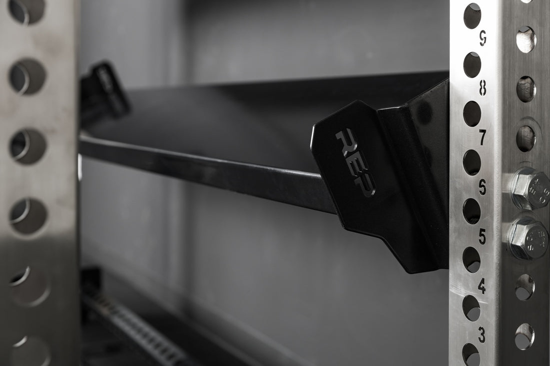 Close-up of the REP Fitness branding on the 82" Dumbbell & Kettlebell Shelf
