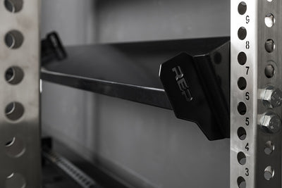 Close-up of the REP Fitness branding on the 82" Dumbbell & Kettlebell Shelf