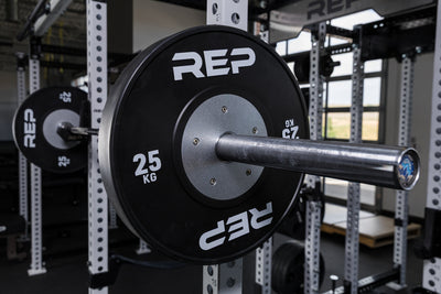 Black Competition Bumper Plates (KG) loaded onto a barbell racked on a PR-5000 rack