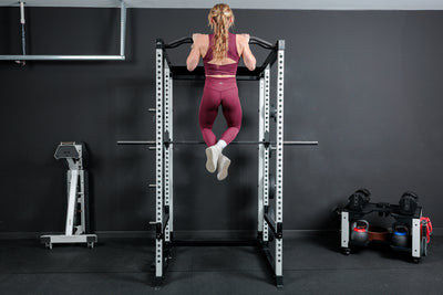 Athlete doing pull-ups on the multi-grip pull-up bar on the REP Fitness Altitude™ Power Rack