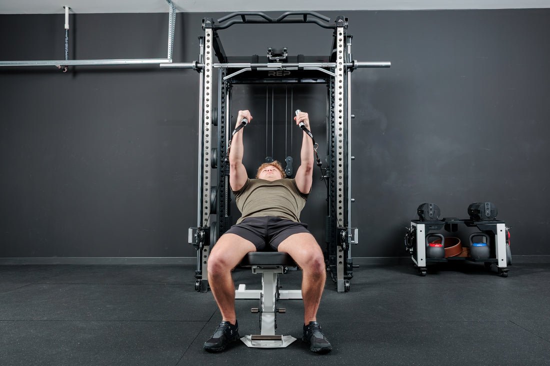 Athlete doing a cable fly workout on a bench with the REP Fitness Altitude™ Power Rack Cable Attachment