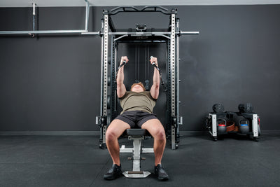 Athlete doing a cable fly workout on a bench with the REP Fitness Altitude™ Power Rack Cable Attachment