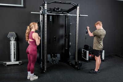 Two athletes using the REP Fitness Altitude™ Power Rack with Cable Machine Attachment at the same time