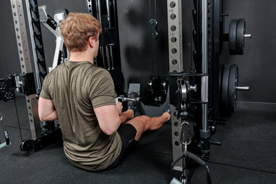 Athlete doing seated low row on the ground with the REP Fitness Altitude™ Power Rack Cable Attachment