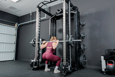 Athlete squatting using the REP Fitness Altitude™ Power Rack Smith Machine Attachment