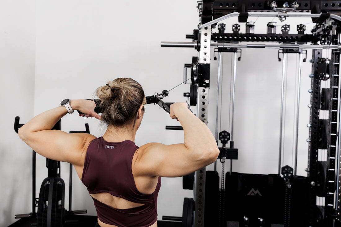 Person performing cable face pulls with the Ares™ 2.0 on the Summit™ All-In-One Ares™ 2.0 configuration in a gym setting.