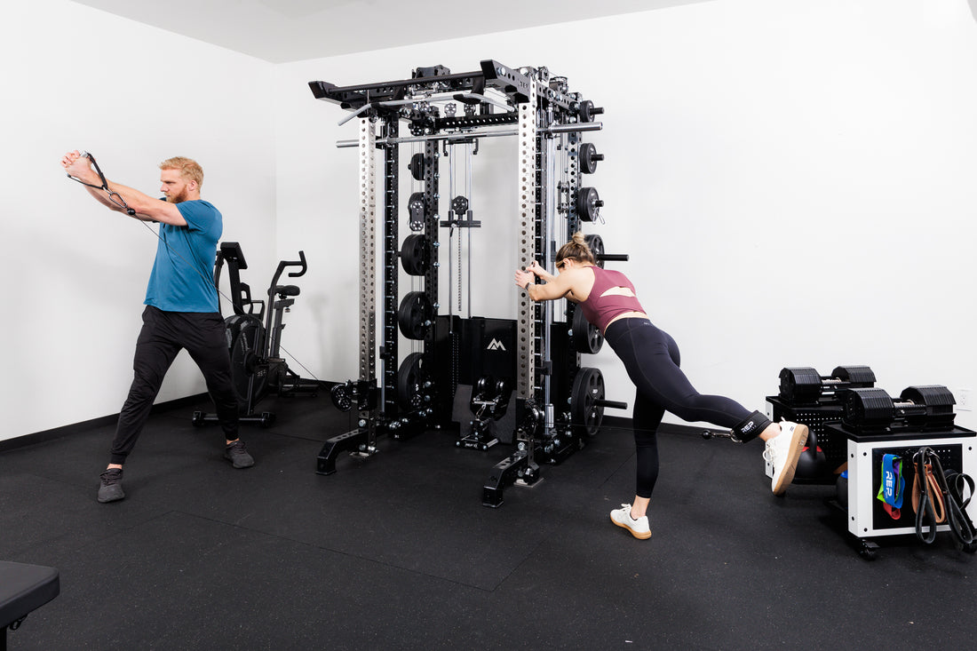 Two people performing cable machine exercises on the Summit™ All-In-One Ares™ 2.0 Upgrade Kit  in a gym setting.