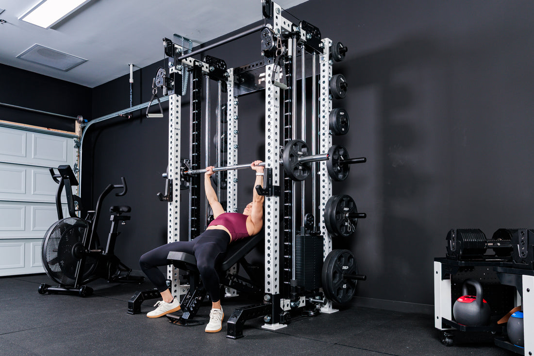 Women using the Smith Machine Rack Attachment for incline bench on the Summit™ All-In-One Trainer with Athena™in a home gym setting.