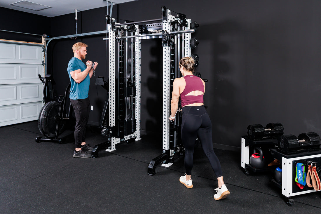 Two people working out on the
Summit™ All-In-One Trainer with Athena™in a home gym setting.