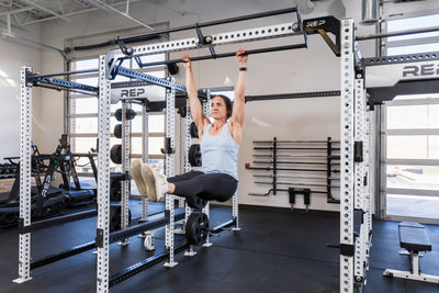 Athlete hanging from the REP Fitness Double Pull-Up Bar on an 82 inch crossmember