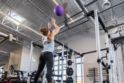 Athlete doing wall balls on the REP Fitness Crossmember Mount Wall Ball Target