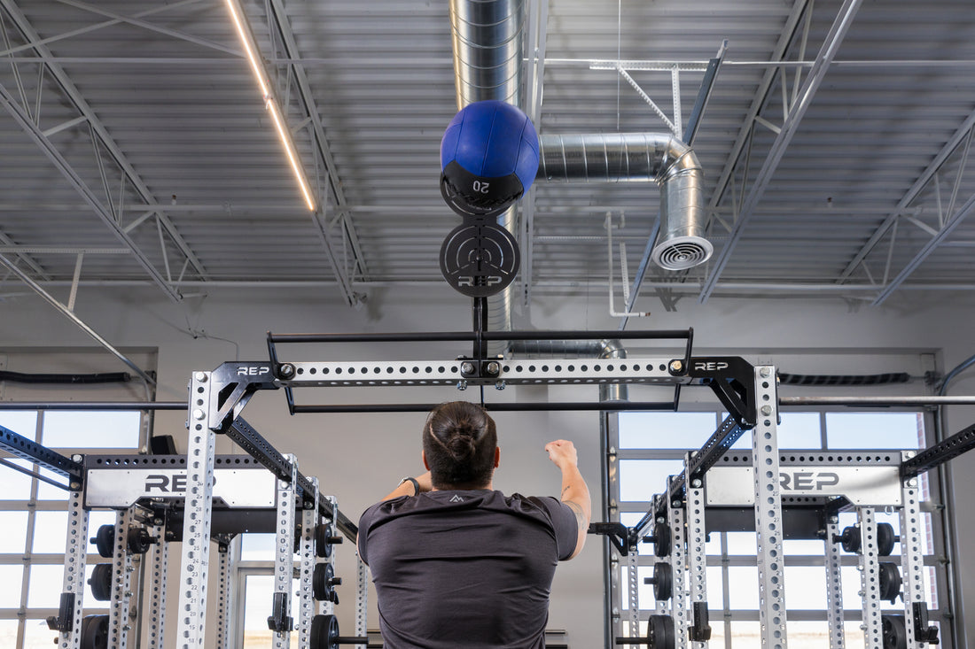 Athlete doing wall balls on the REP Fitness Crossmember Mount Wall Ball Target