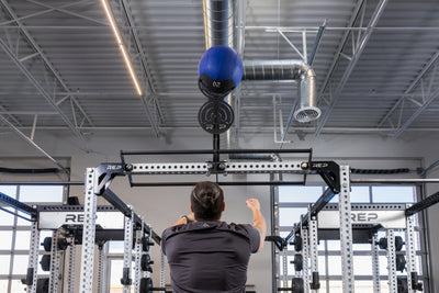 Athlete doing wall balls on the REP Fitness Crossmember Mount Wall Ball Target
