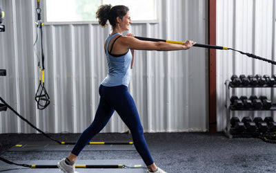 Side shot: Athlete working out with the TRX® Rip Trainer™ extended in front of them