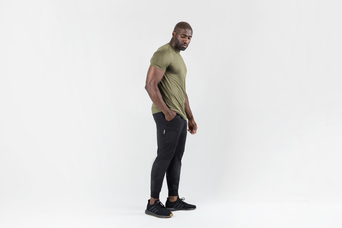 The REP Fitness Men's Apollo Joggers in Heather Black front, lifestyle 3/4 angle
