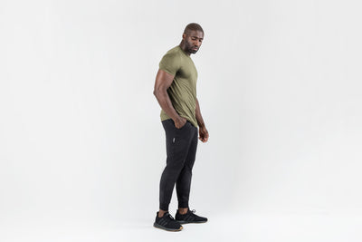 The REP Fitness Men's Apollo Joggers in Heather Black front, lifestyle 3/4 angle