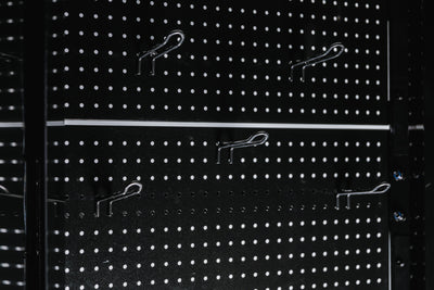 Pegboard storage hooks on a black Arcadia Max