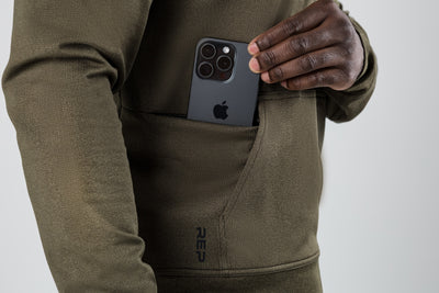 The REP Fitness Men's Attis Jacket in Heather Olive front, phone pocket detail