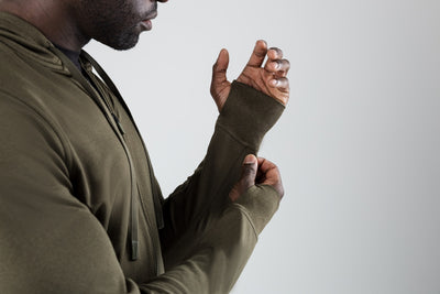 The REP Fitness Men's Attis Jacket in Heather Olive front, side profile, thumbhole