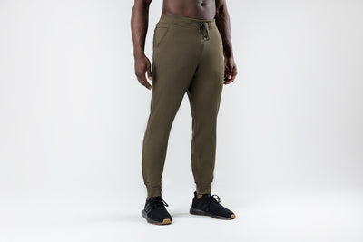 The REP Fitness Men's Attis Joggers in Heather Olive front, hands near pockets