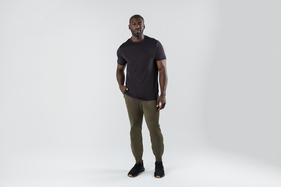 The REP Fitness Men's Attis Joggers in Heather Olive front, with black tee