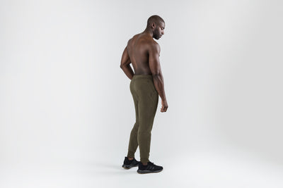 The REP Fitness Men's Attis Joggers in Heather Olive back, looking over shoulder