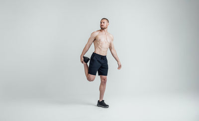 The REP Fitness Men's Apollo Shorts in Heather Navy/Cool Gray front, stretching