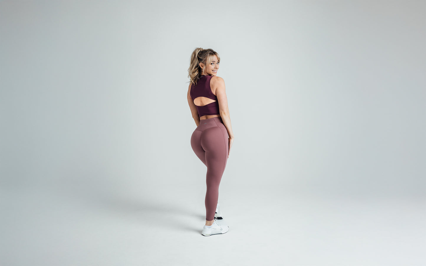 Back shot of an athlete wearing the REP Rhea Tank in Wine