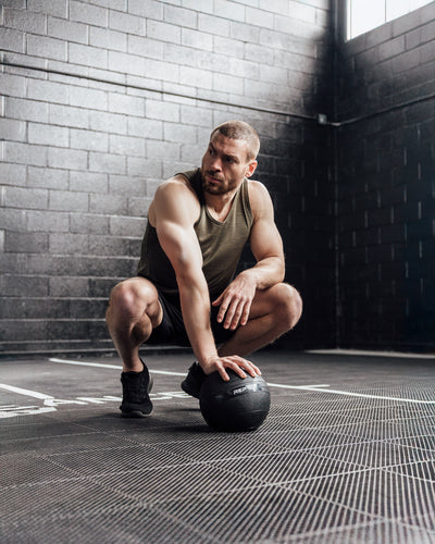 The REP Fitness Men's Sigmatech Tank Top in Heather Olive front, crouched