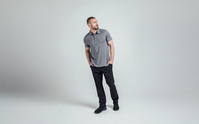 The REP Fitness Men's Audax Performance Polo in Heather Cool Gray/Black front, head turned