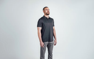 The REP Fitness Men's Audax Performance Polo in Heather Black/Cool Gray front, 3/4 angle