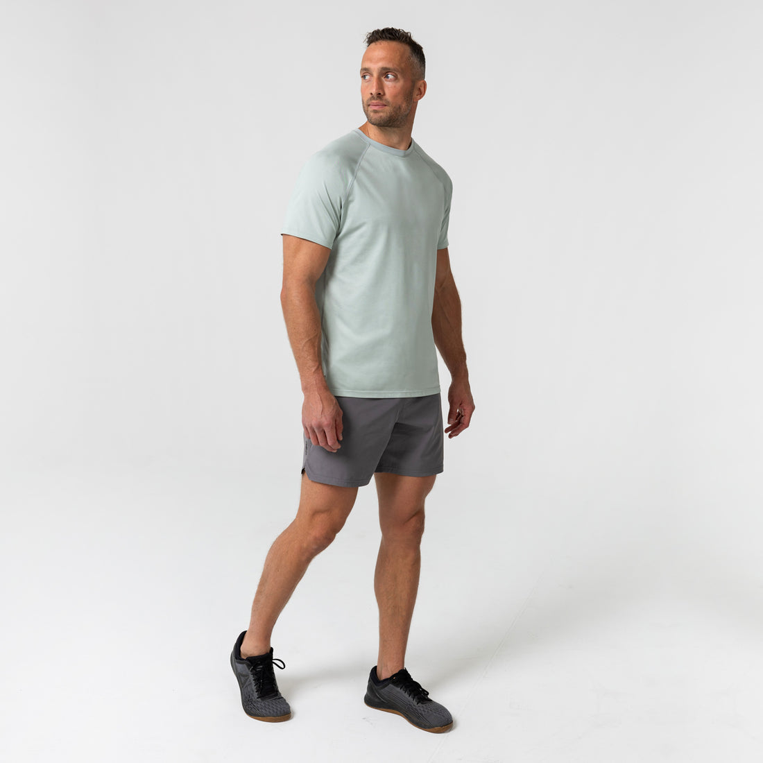 The REP Fitness Men's Aerix Tee in Heather Aqua Gray front, walking