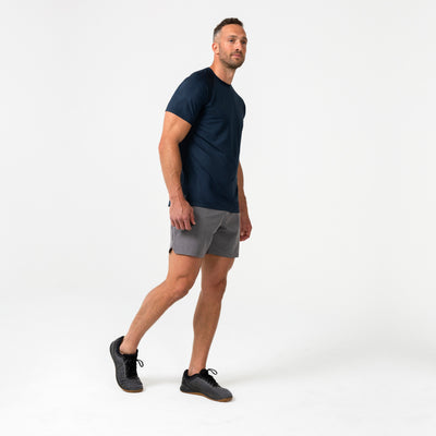 The REP Fitness Men's Aerix Tee in Heather Navy front, walking