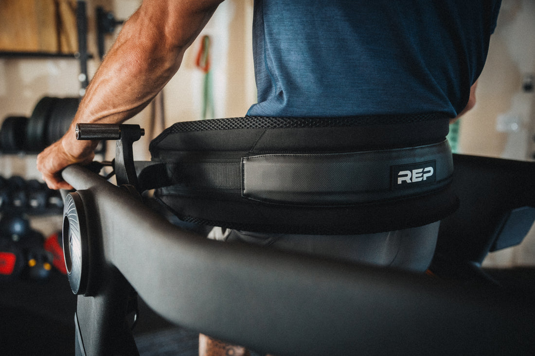 Athlete leaning backwards into the Belt Squat Belt on the Strive Curved Treadmill