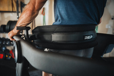 Athlete leaning backwards into the Belt Squat Belt on the Strive Curved Treadmill