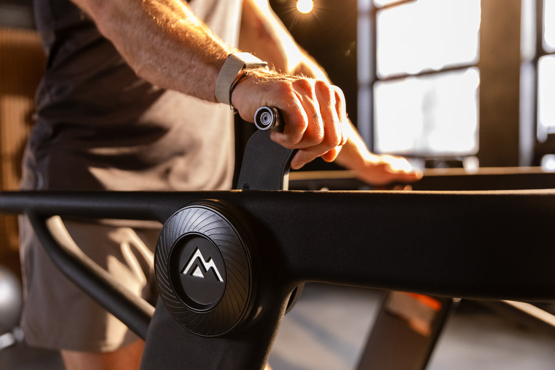 Athlete changing the resistance level of the Strive Curved Treadmill
