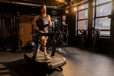 Athlete jogging in run mode on the REP Fitness Strive Curved Treadmill